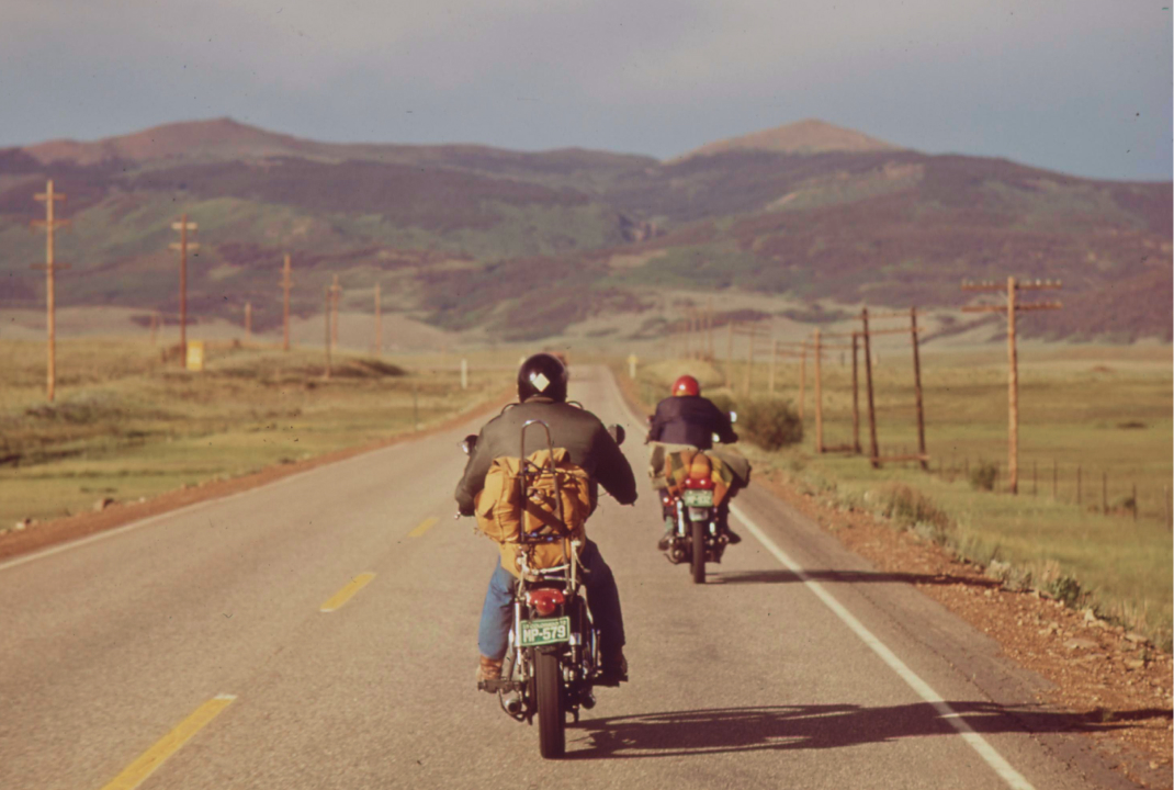 Vacationers on motorcycles, by Boyd Norton